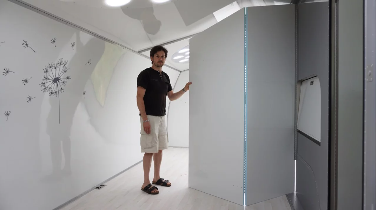 A folding wall splits the bedroom area in two