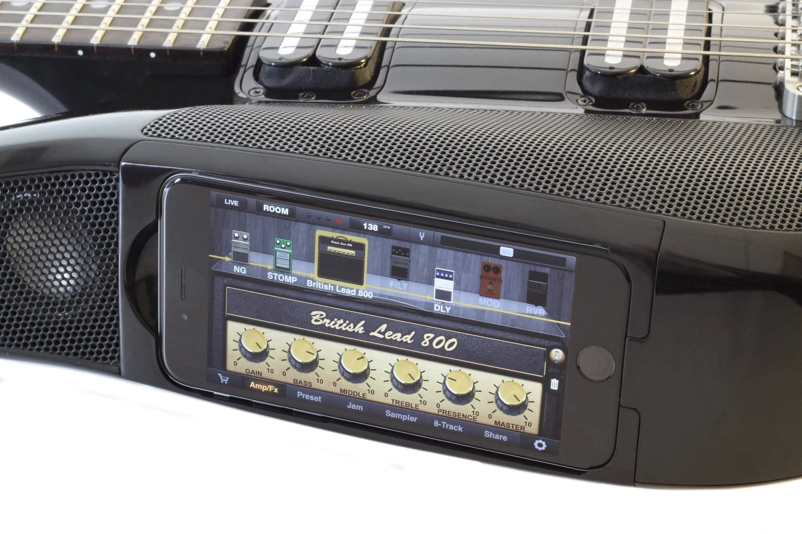 An iPhone running music production apps is docked in the Fusion Guitar to the top