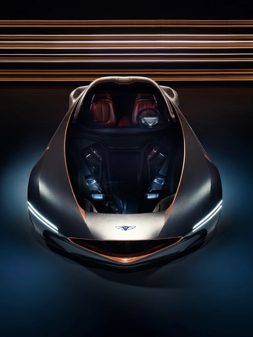 Genesis emphasizes the Essentia's carbon fiber monocoque and suspension with a transparent hood