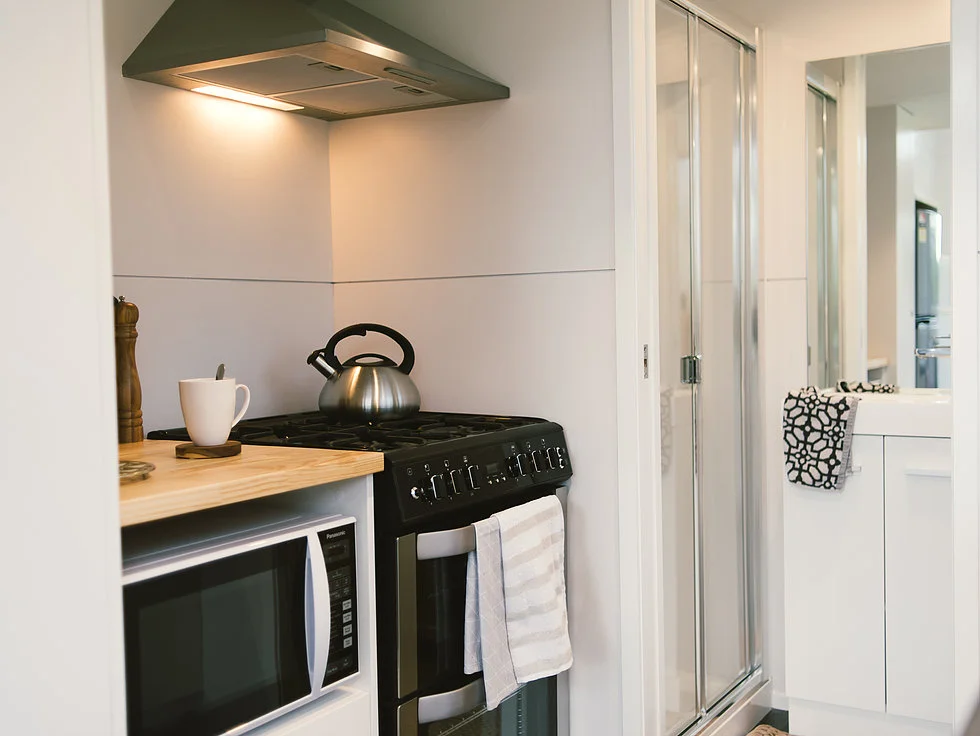 The Buster Tiny House's kitchen includes four-burner propane-powered oven