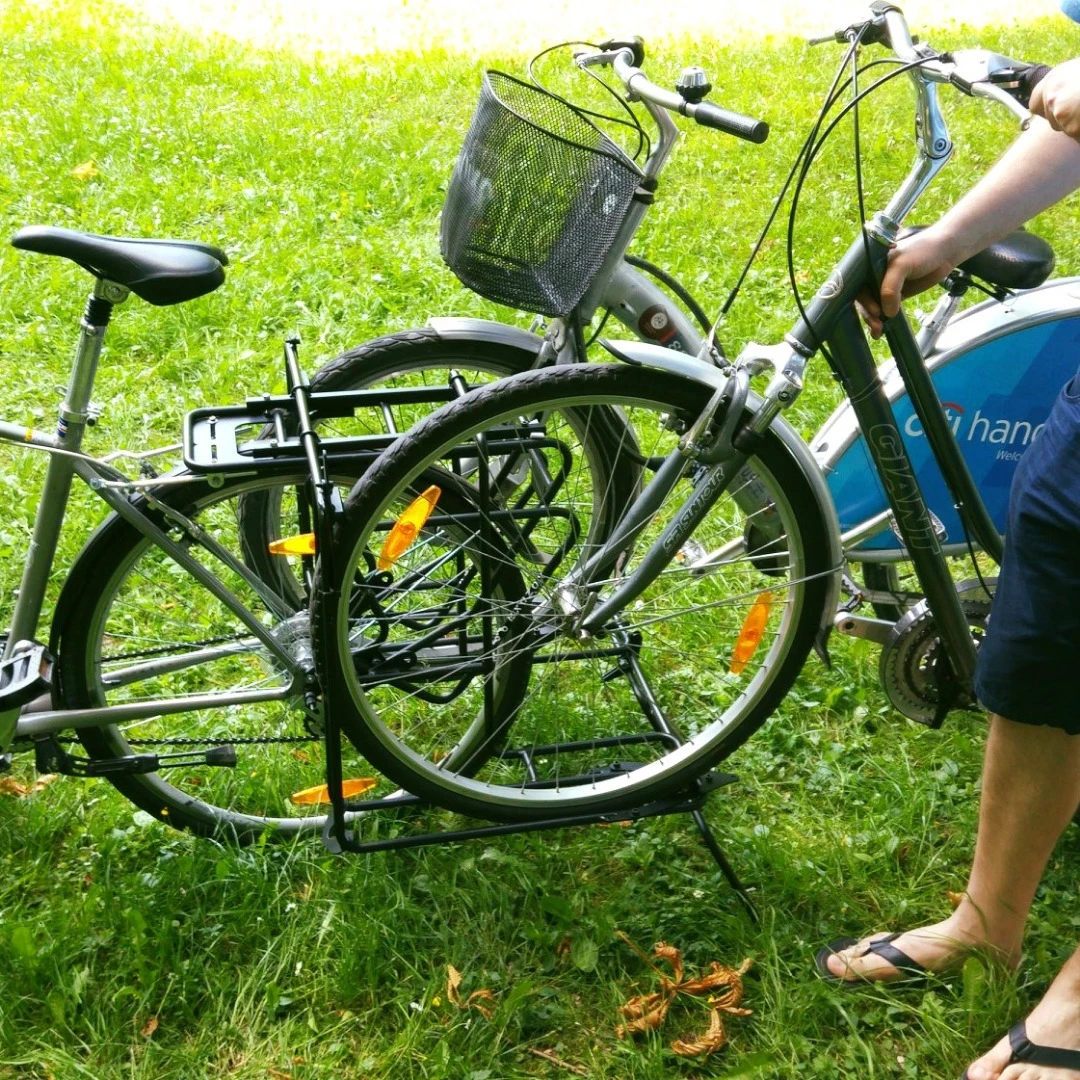 Users simply slot the front wheels of the two bikes-to-be-towed into the Exozox's holders, then run a bungee cord from each of the holders around the back of the towed bikes' head tubes