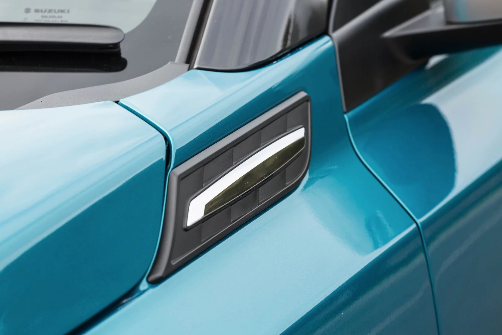 Suzuki has dipped into the tinsel box and added plenty of fake vents and colorful touches to the Vitara Turbo