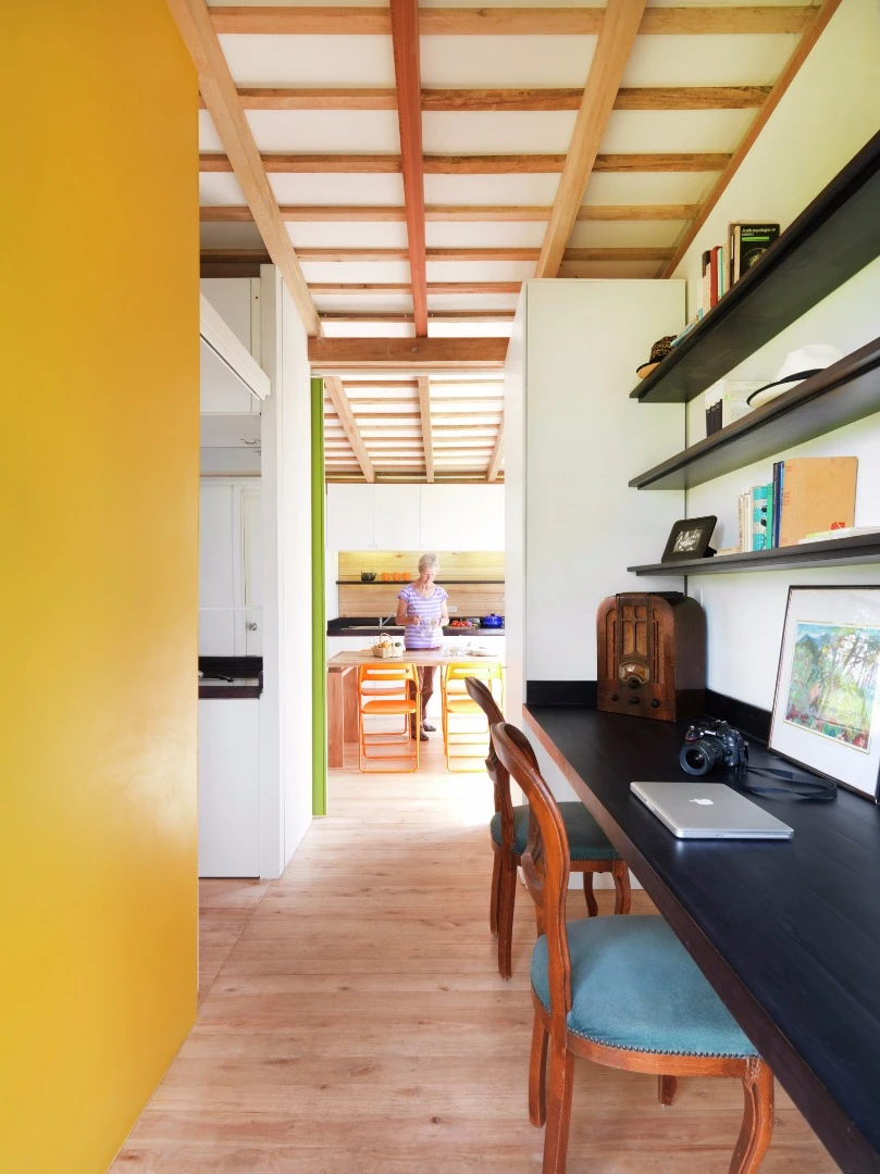The second entrance to the home leads into a study area, complete with a built-in desk and room for two people