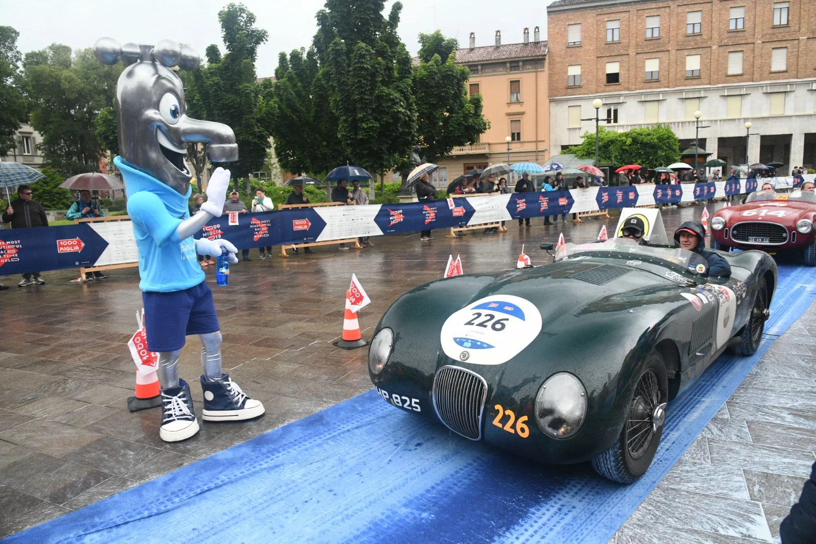 A 1952 Jaguar C-Type is greeted by a large tap