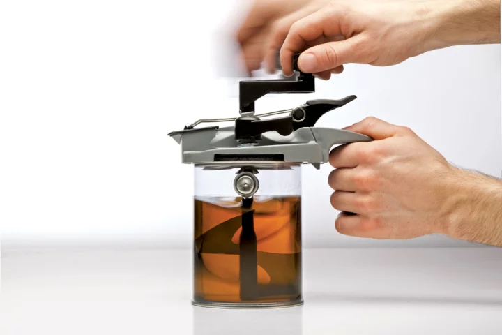 The Mixing Mate attaches to a paint can to easily stir paint, pour it out smoothly, and even seal it for later