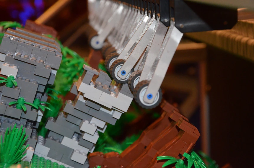 The bricks on the surface of the barrel strike arms that trigger keys on the built-in keyboard