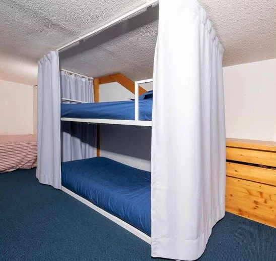Draw curtains provide simple privacy for the bunk beds