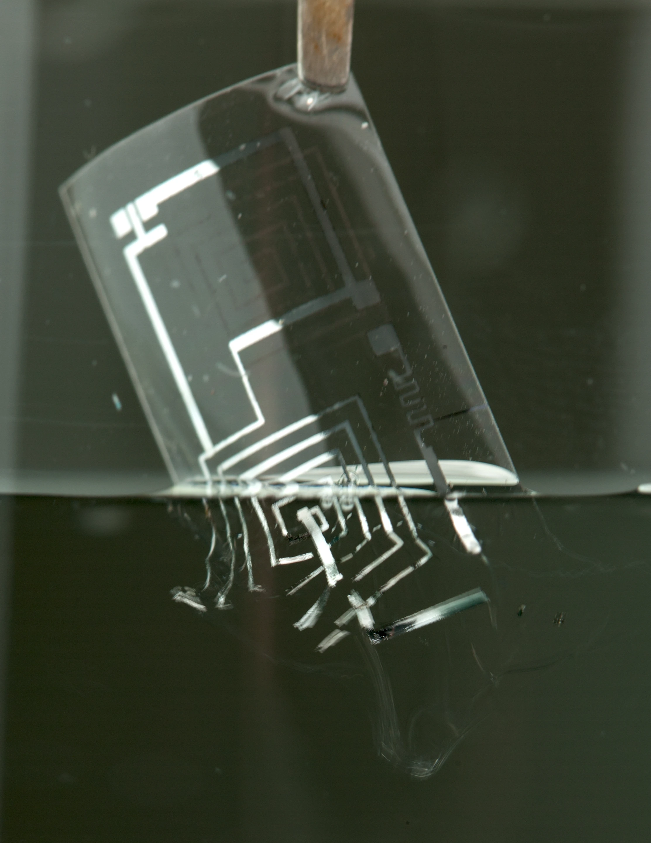 Example of transient electronics being immersed in water where it begins to dissolve