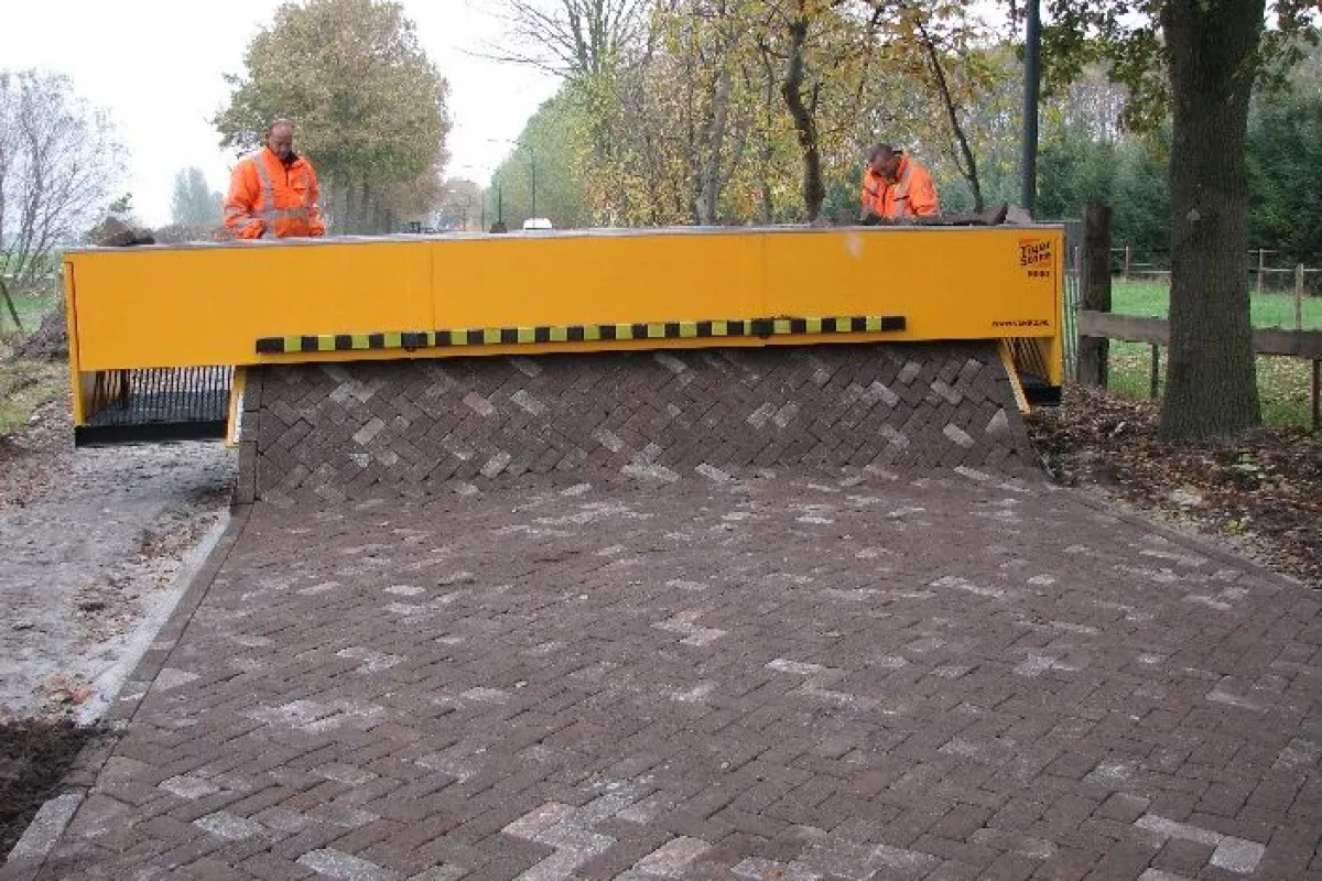 The Tiger Stone laying a brick road