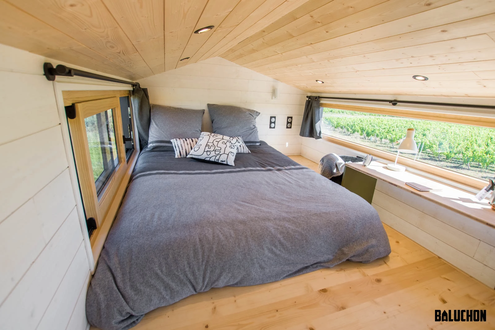 The Tiny House Sauvage's bedroom has a typical tiny house loft-style low ceiling