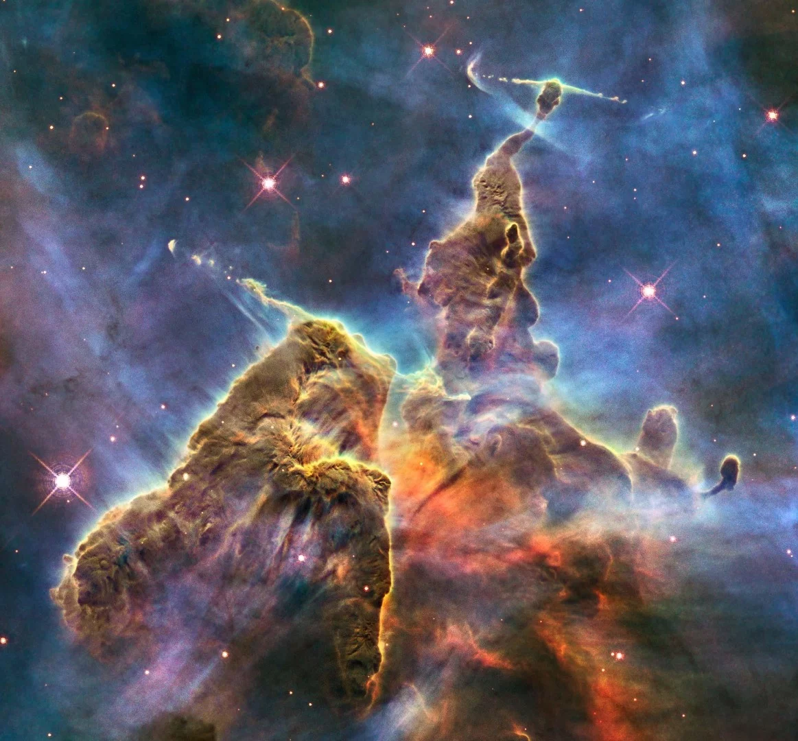 This image shows the top section of a three-light-year-tall pillar of gas in the Carina Nebula. The cloud is being eaten from the inside by infant stars as they form and fire up.