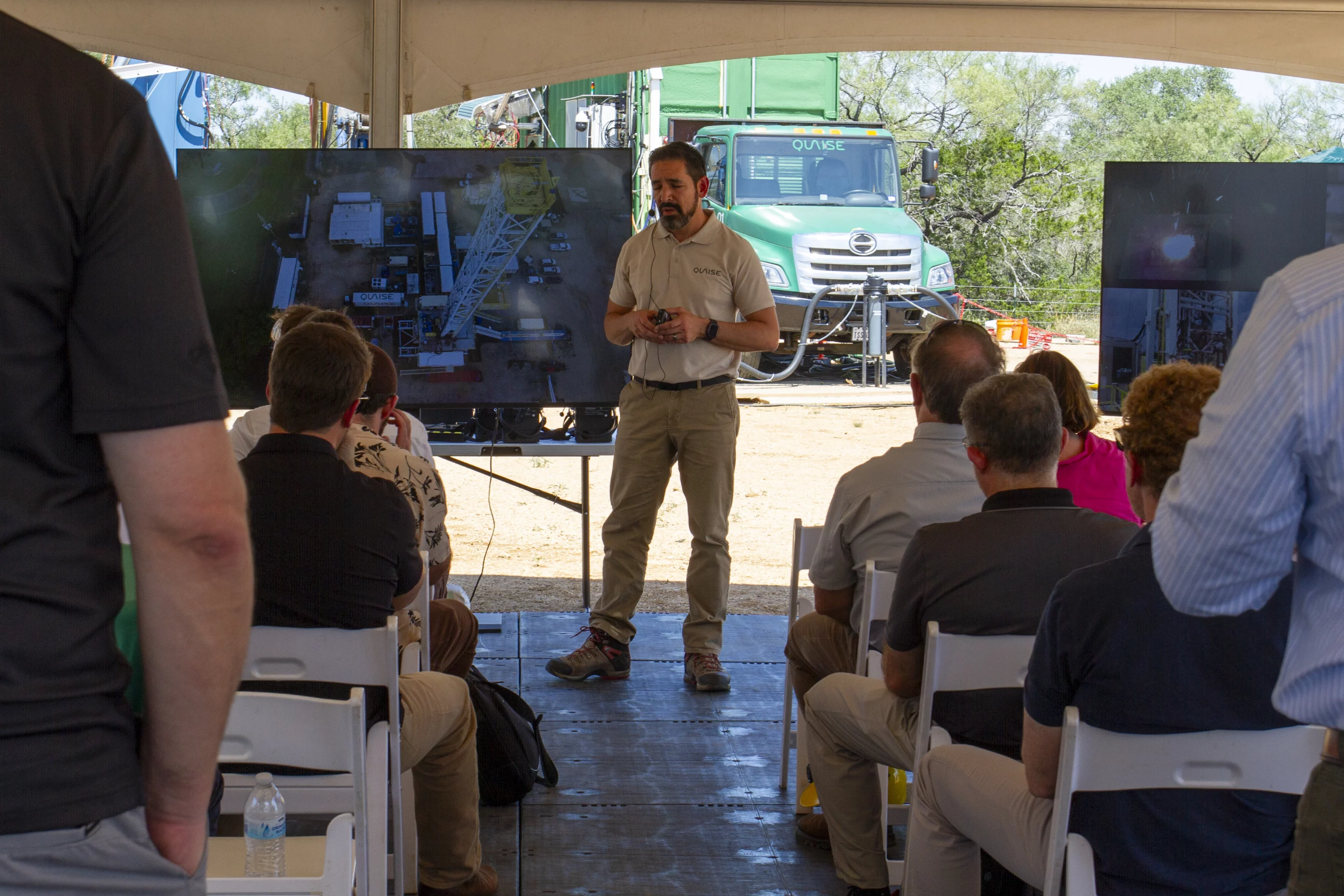 Quaise CEO Carlos Araque gives the audience technical details regarding the operation in Marble Falls, Texas, with the millimeter-wave tech in the background