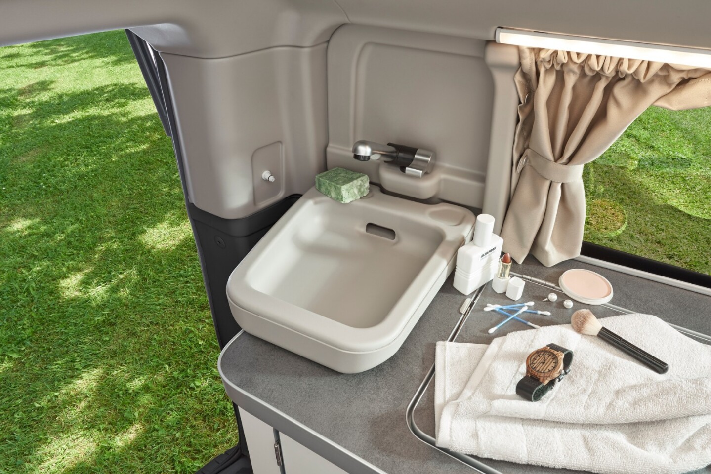 Hidden away at the far corner of the kitchen area is a drop-down bathroom sink