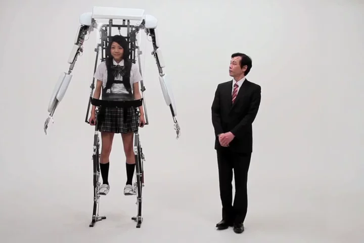 A school girl wearing Sagawa Electronics' Power Jacket MK3 stands above a grown man