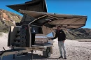The frontmost storage hatch on the left side of travel has a slide-out fridge drawer down low, the heating system above
