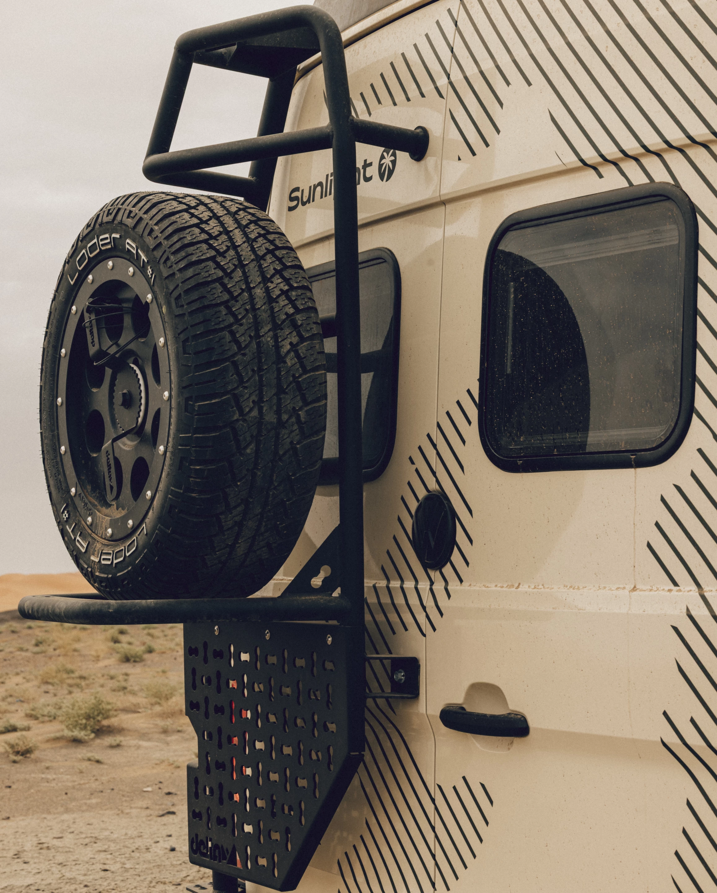 Much like your typical American adventure camper van, the Sunlight Ibex wears some functional jewelry, including its spare tire carrier with lash panel