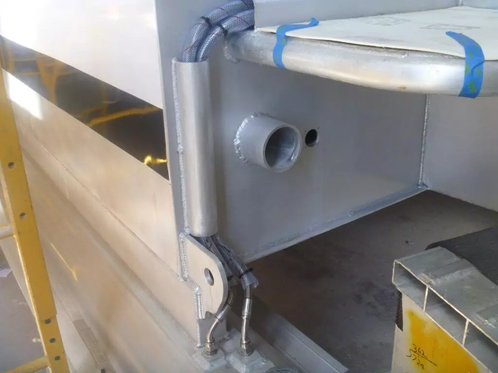 Fuel lines at the stern of the skis rising to the transom pod where the outboard engines are mounted – also visible is the 4-in self-draining outlet