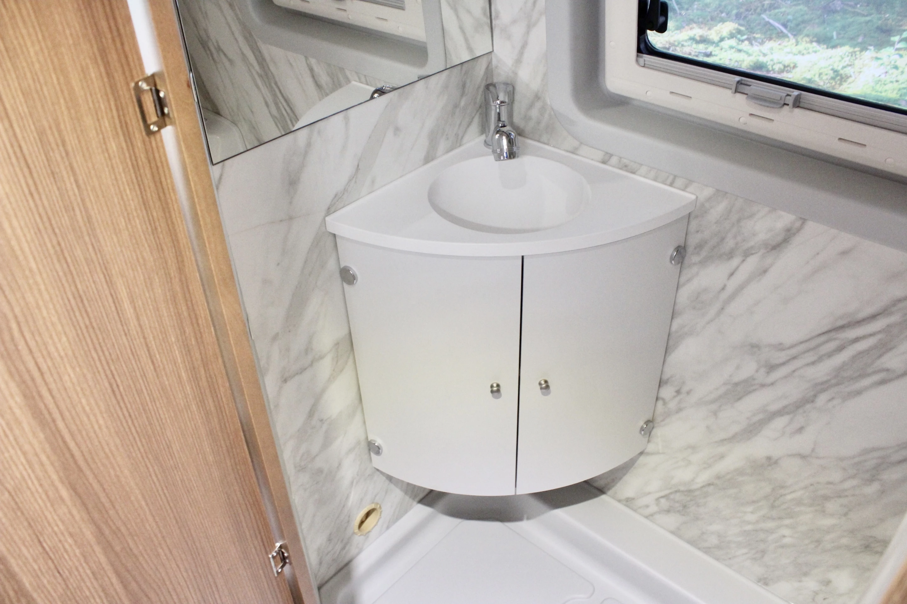 Corner sink and marble-look surfacing in the Swan 699 wet bath