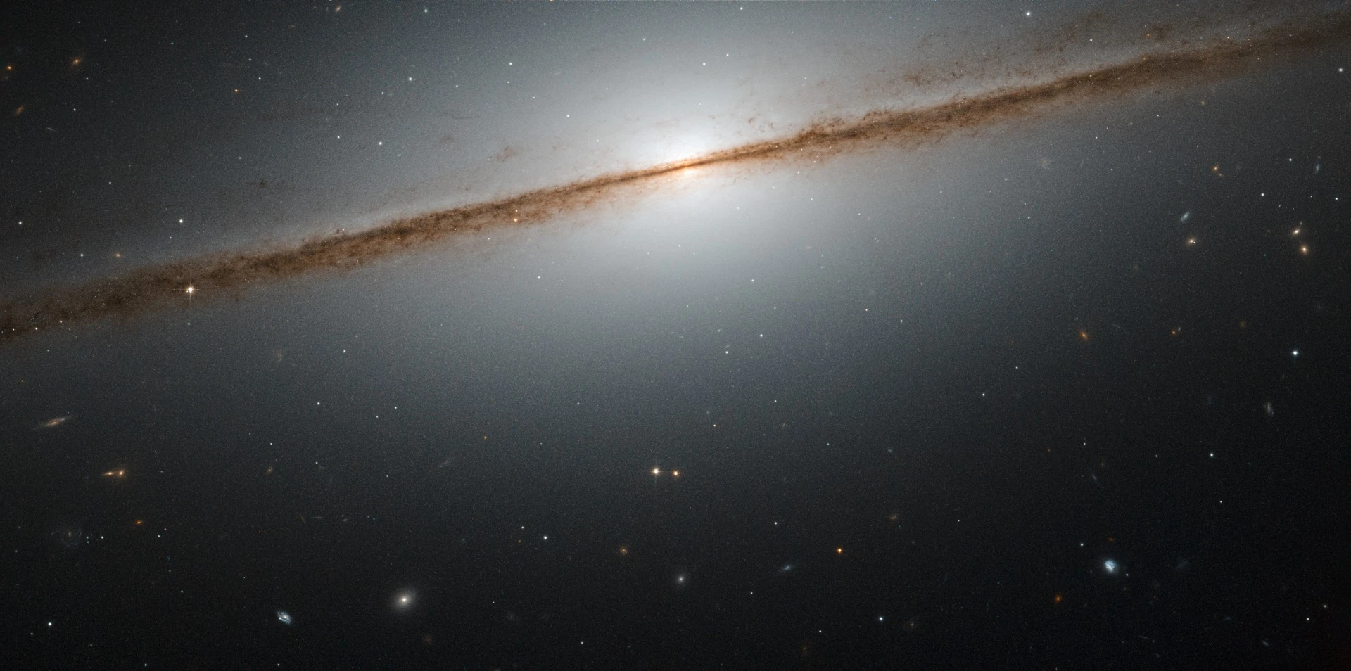 This is NGC 7814, also known as the “Little Sombrero”. Its larger namesake the Sombrero Galaxy is another stunning example of an edge-on galaxy — in fact, the “Little Sombrero” is about the same size as its bright namesake at about 60 000 light-years across, but as it lies further away, it appears smaller in the sky