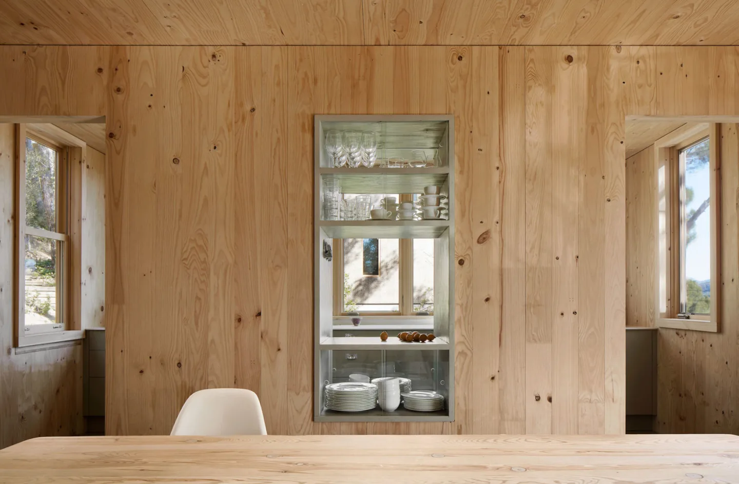 The home also boasts built-in timber furniture, including display cabinets in the kitchen and timber dining table