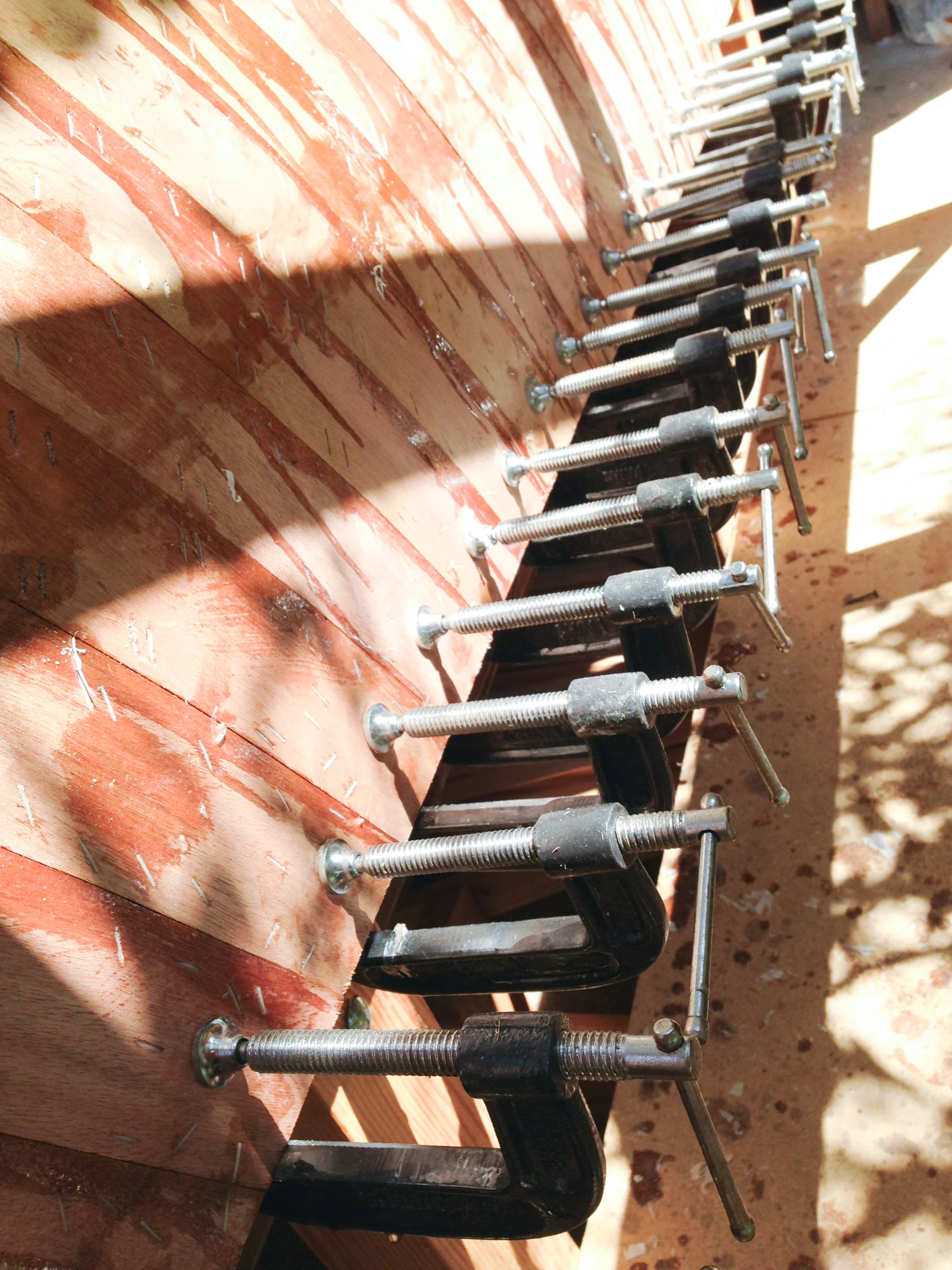 Though screws are used in the construction process to bring the wood together, these are then removed in favor of epoxy and plastic staples designed specifically for boat building (Photo: Chris Robinson)