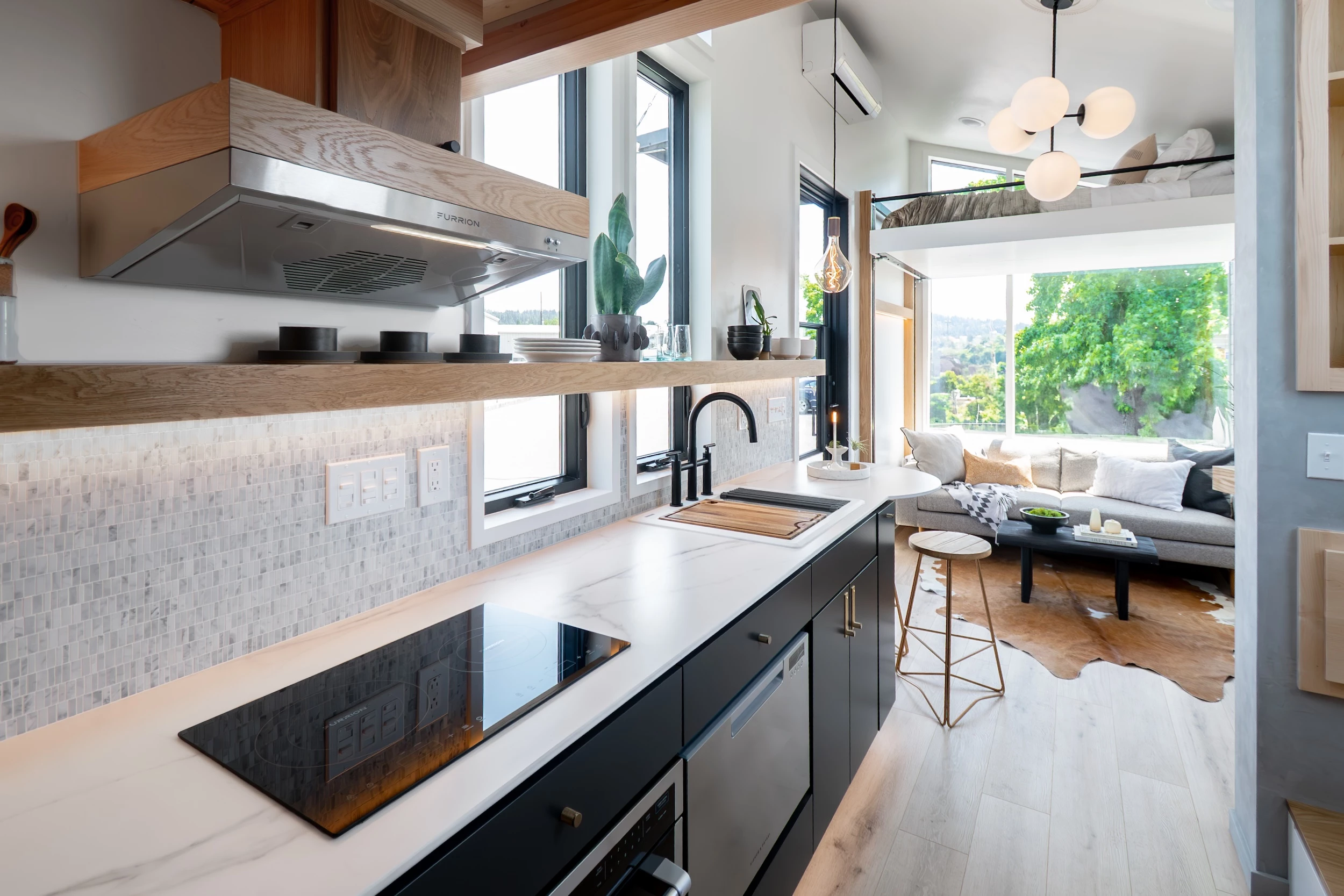 The Terra Urban's kitchen includes an induction cooktop, oven, microwave, dishwasher, and fridge/freezer