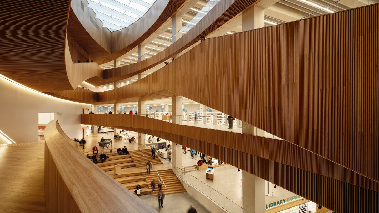 Calgary Central Library's atrium is defined by a double-curved shell and topped by a decorative oculus