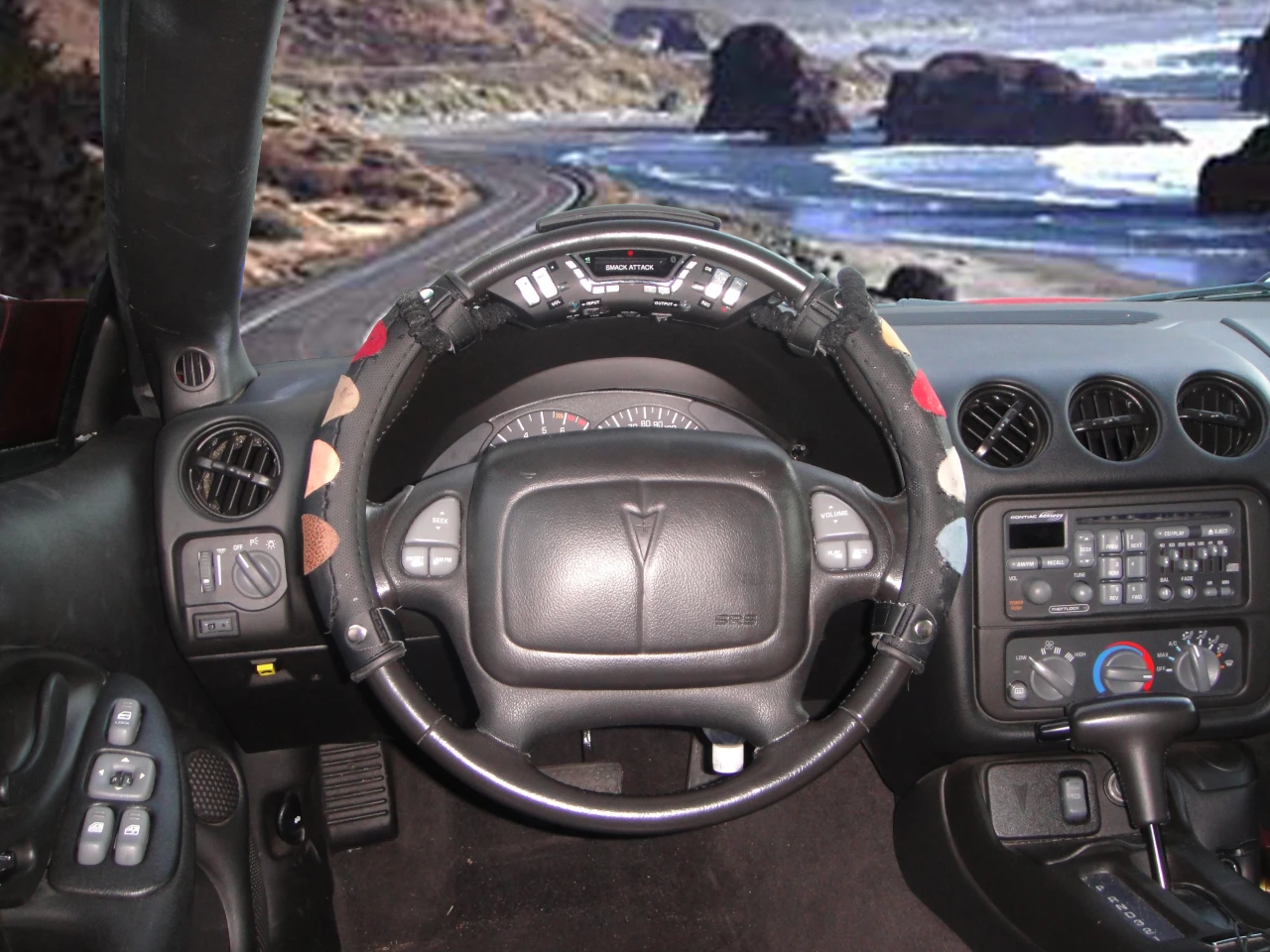 The cover will fit any steering wheel, and features eight color-coded smack sensors, each making a different drum sound when smacked