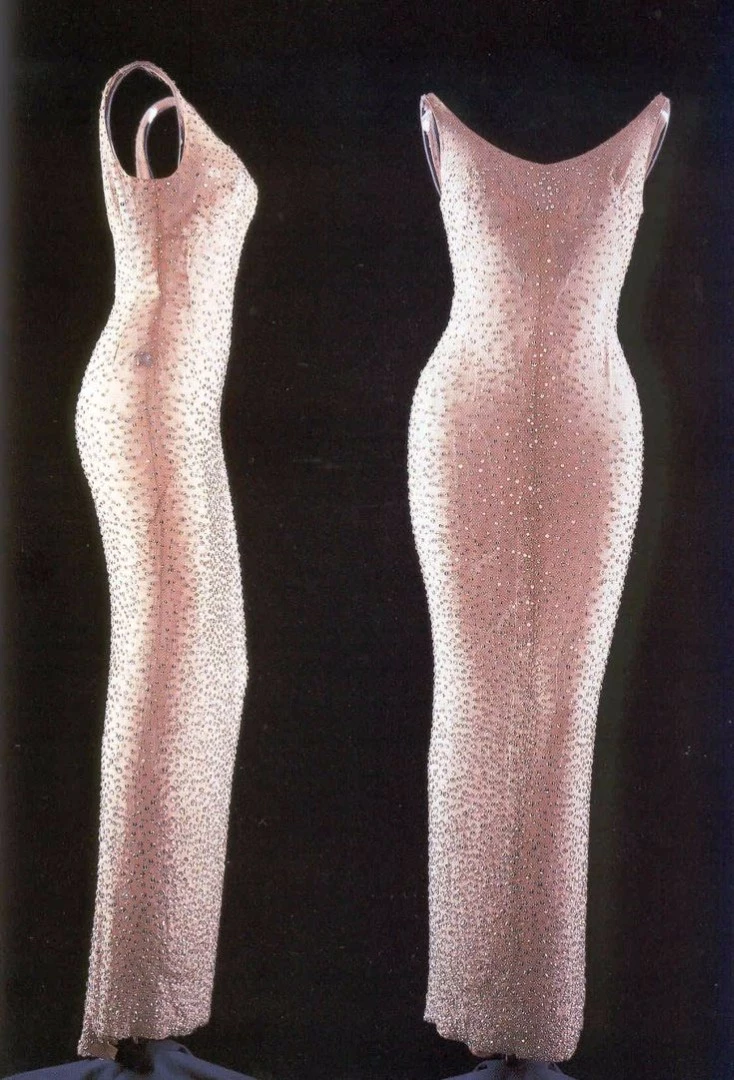 Monroe told the event planners she would dress discreetly, rehearsed in casual clothes, and changed into the dress just prior to the performance, wearing a white fur coat until she was on stage to hide what she was really wearing – a sheer body-hugging dress without any lining, and heels.