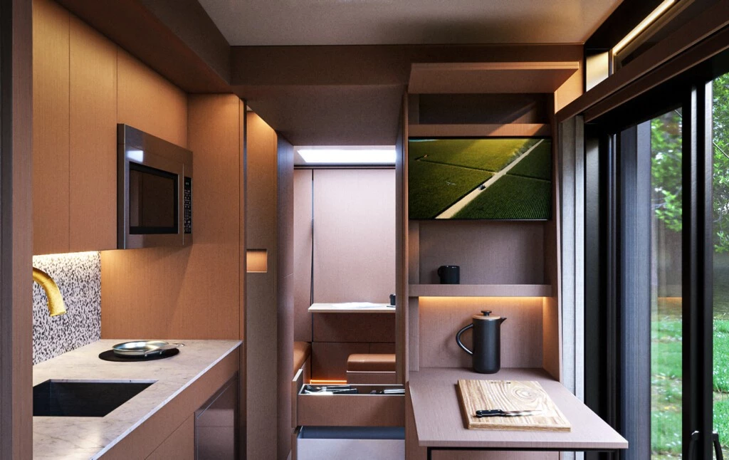 The kitchen includes a microwave, yacht fridge, concealed induction cooktop and fold-down table/work area
