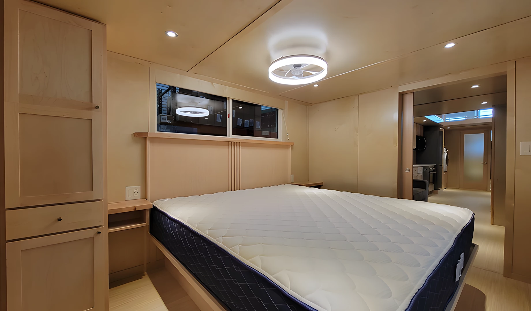 The Ultimate tiny house's master bedroom is spacious and has ample headroom to stand upright