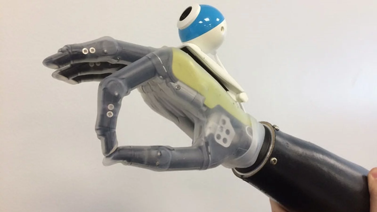 The prototype hand uses an off-the-shelf digital camera to help reach for and grasp objects