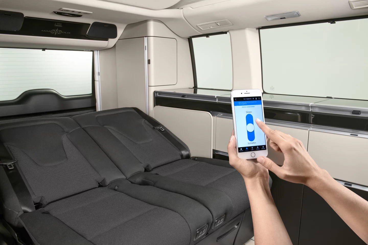 Use the smartphone app to drop the rear seats into bed form