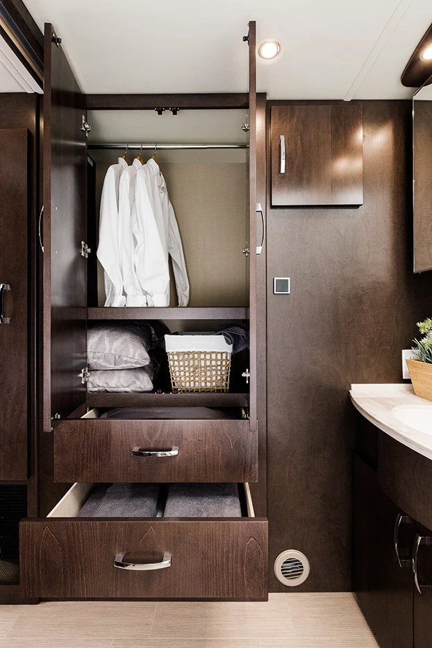 Closet and drawers next to the bathroom