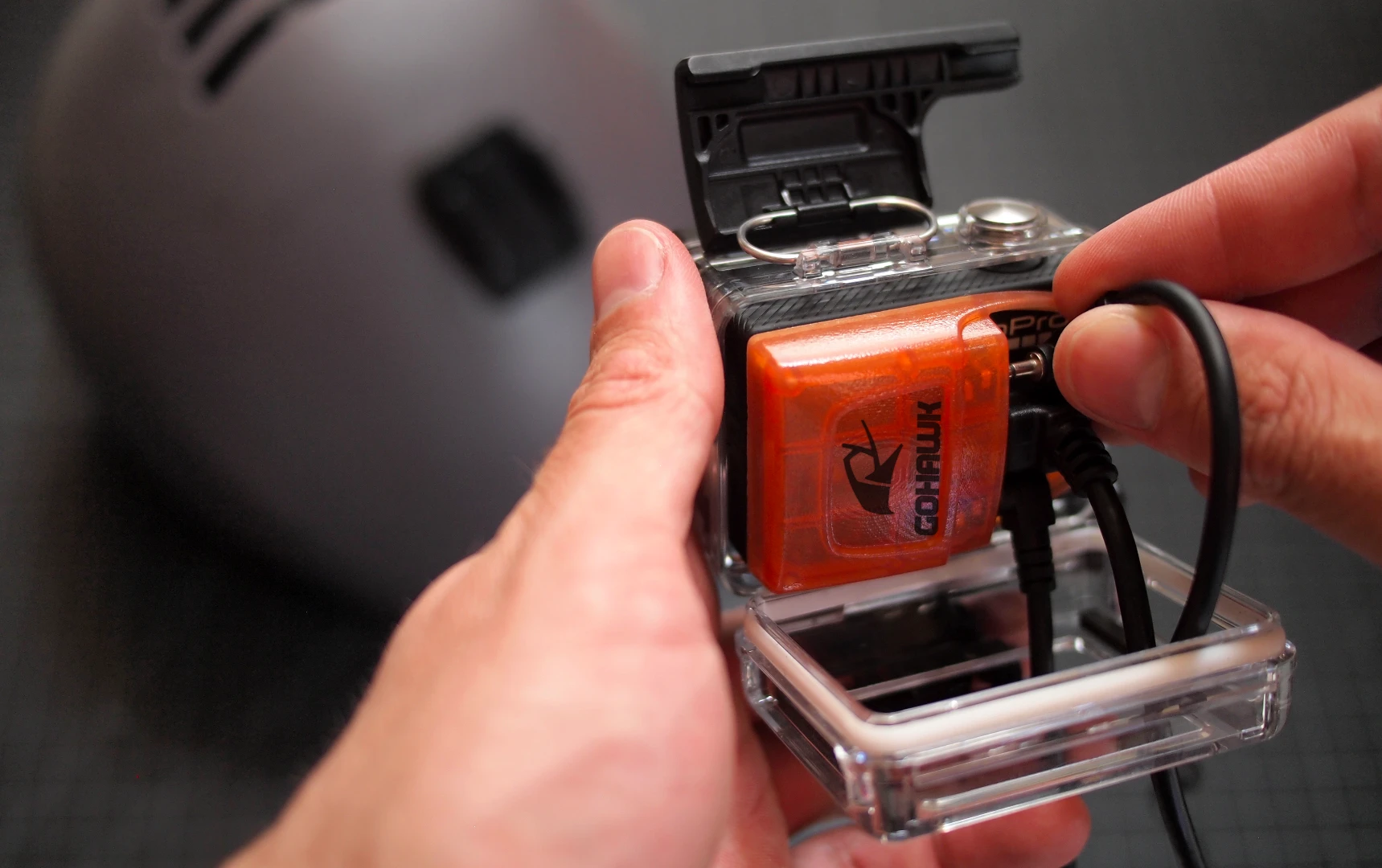 A GoPro housing can still be used with the GoHawk, if it's the type with an opening in the back