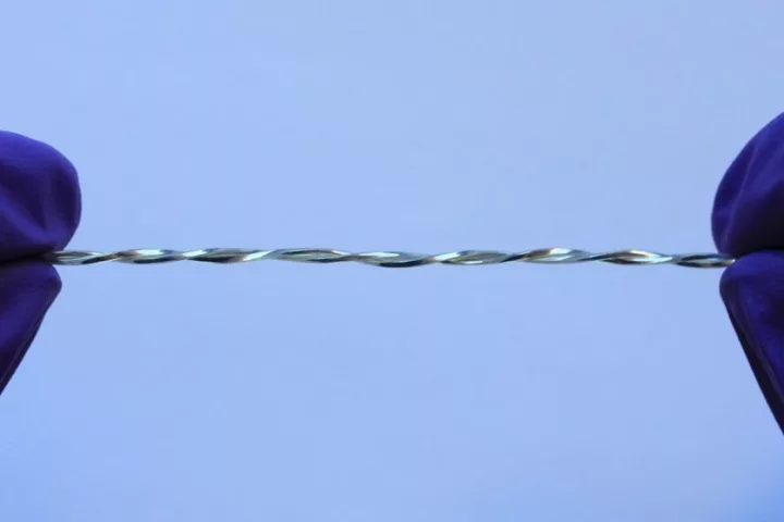 Polymer tubes filled with liquid metal are twisted together to form a conductive fiber