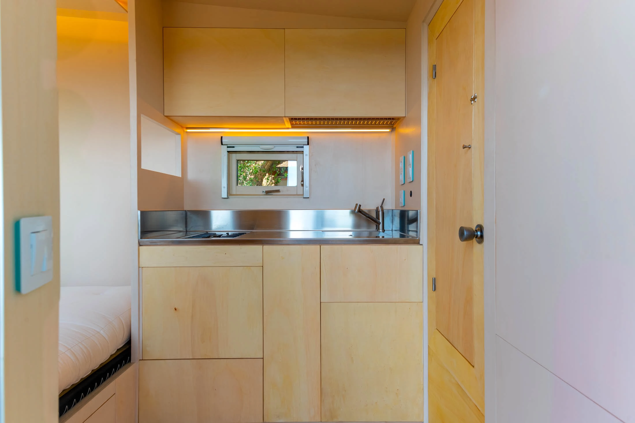 The Freeland Tiny House's custom kitchen area is made from plywood