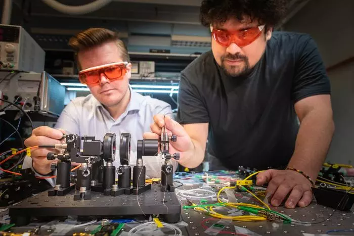 Linnkoping Phd Students Joakim Argillander and Alvaro Alarcón in the lab with the breakthrough PeLED QRNG system