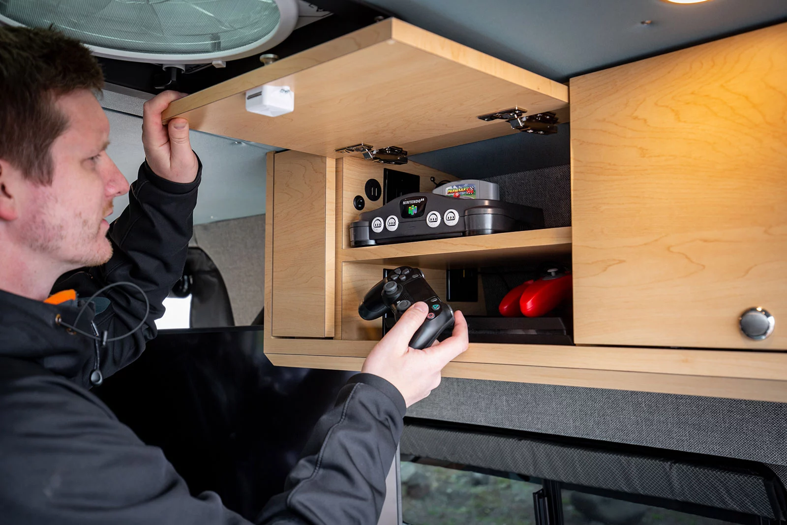 The custom-built cabinet includes electrical outlets, ventilation and shelves for game consoles