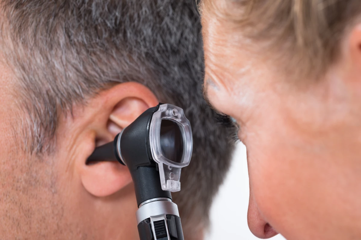 A conventional otoscope, being used to examine a patient's ear