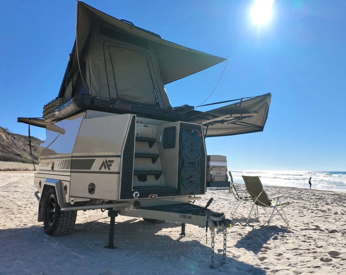 The treaded front chassis platform works as a step and as an above-ground showering platform for the hookup to the looker's left lower corner