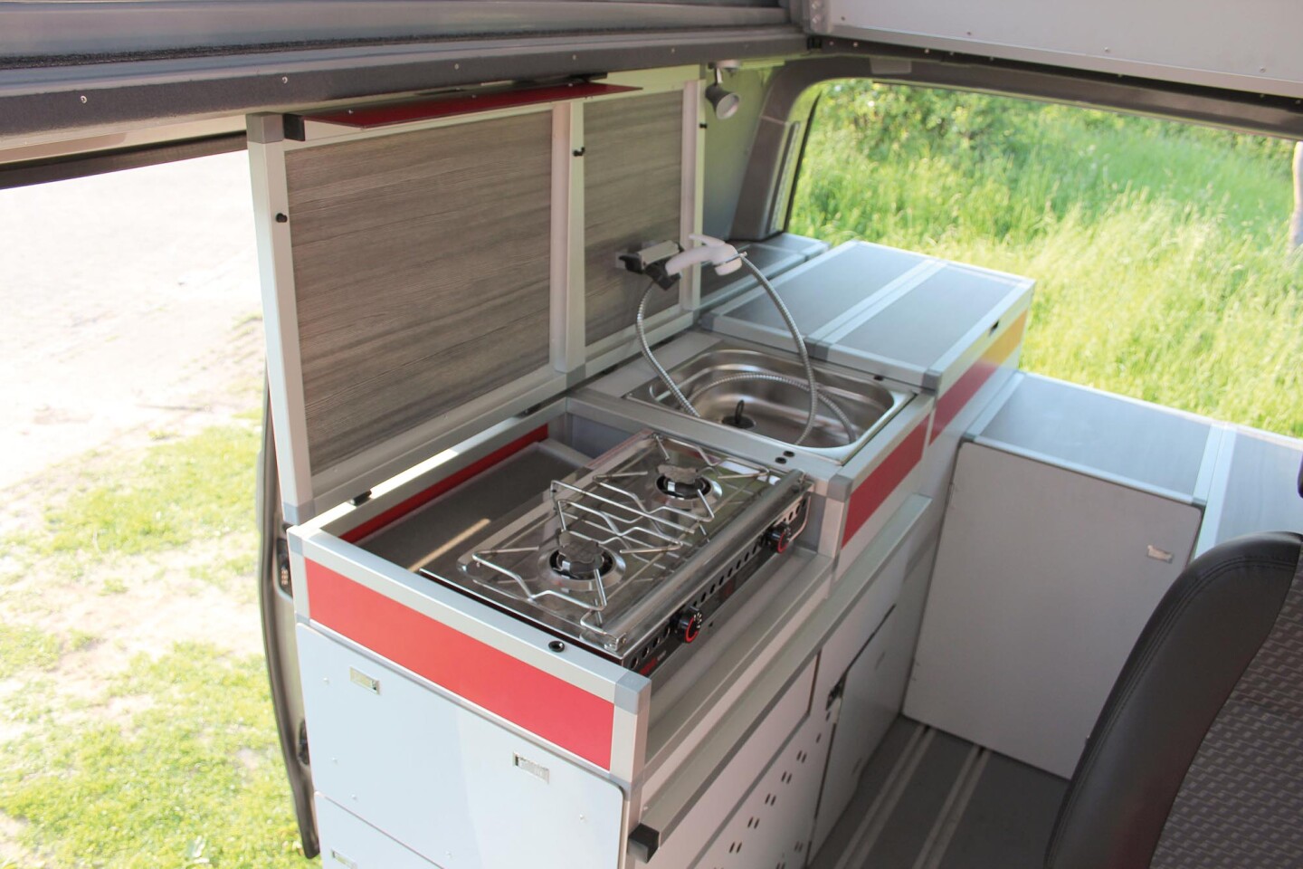The lids of the Terock kitchen fold out of the way to access the sink and available dual-burner indoor/outdoor stove
