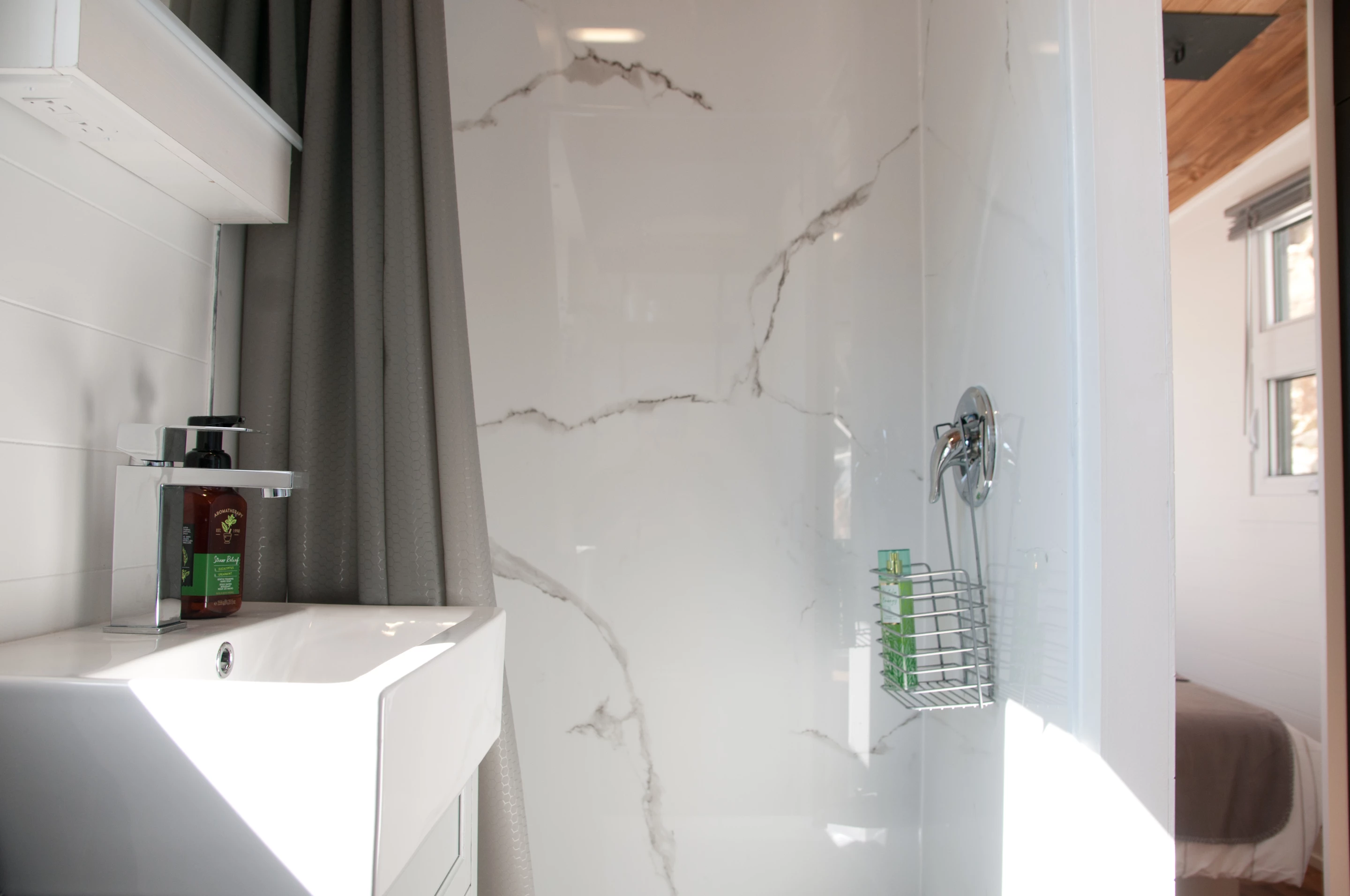 The Nomad's bathroom includes a shower, sink, and toilet