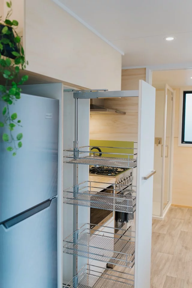 The Green Hill Farm Tiny House's large pull-out kitchen pantry