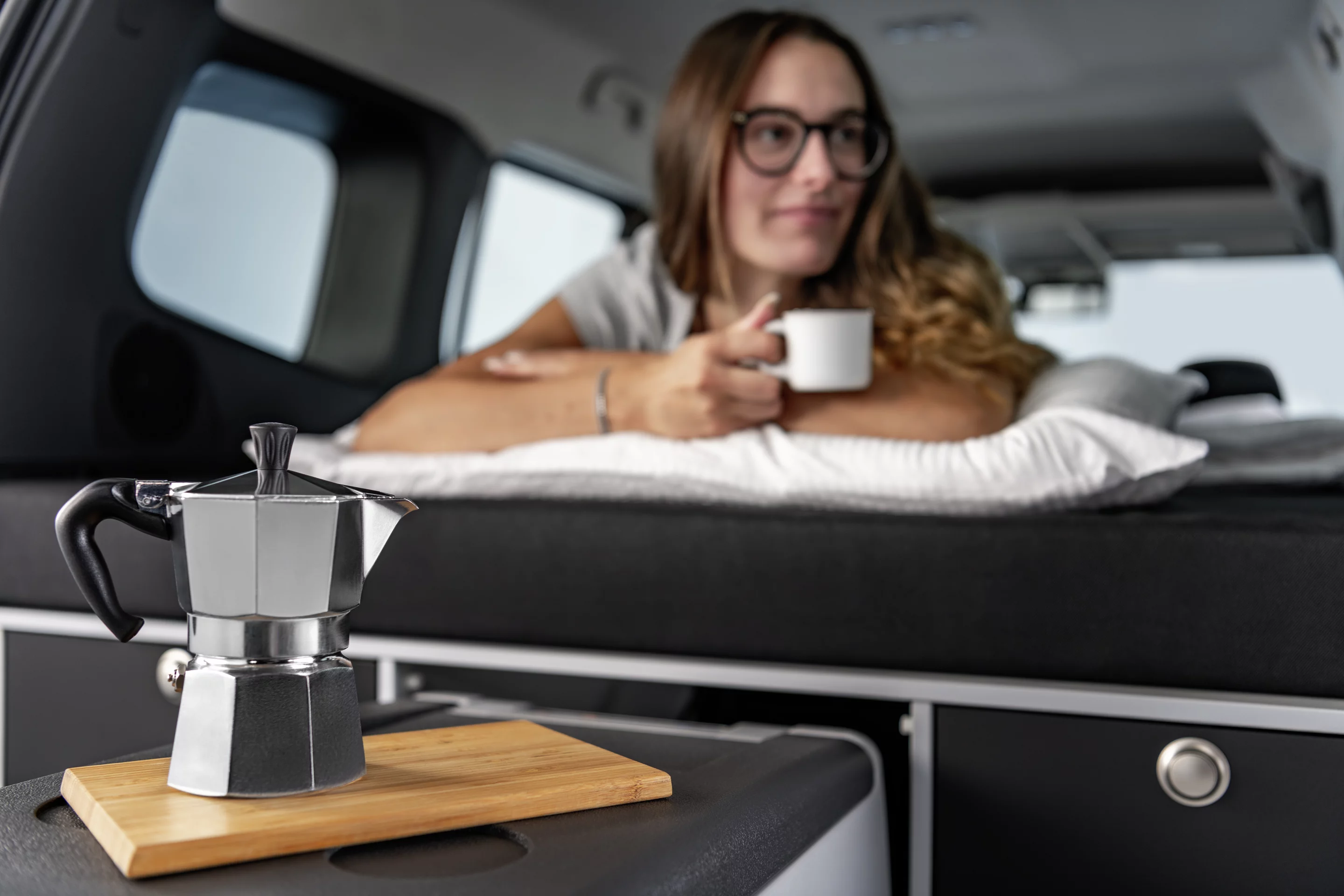 One advantage of the micro-camper van layout is being able to brew coffee from the comfort of bed