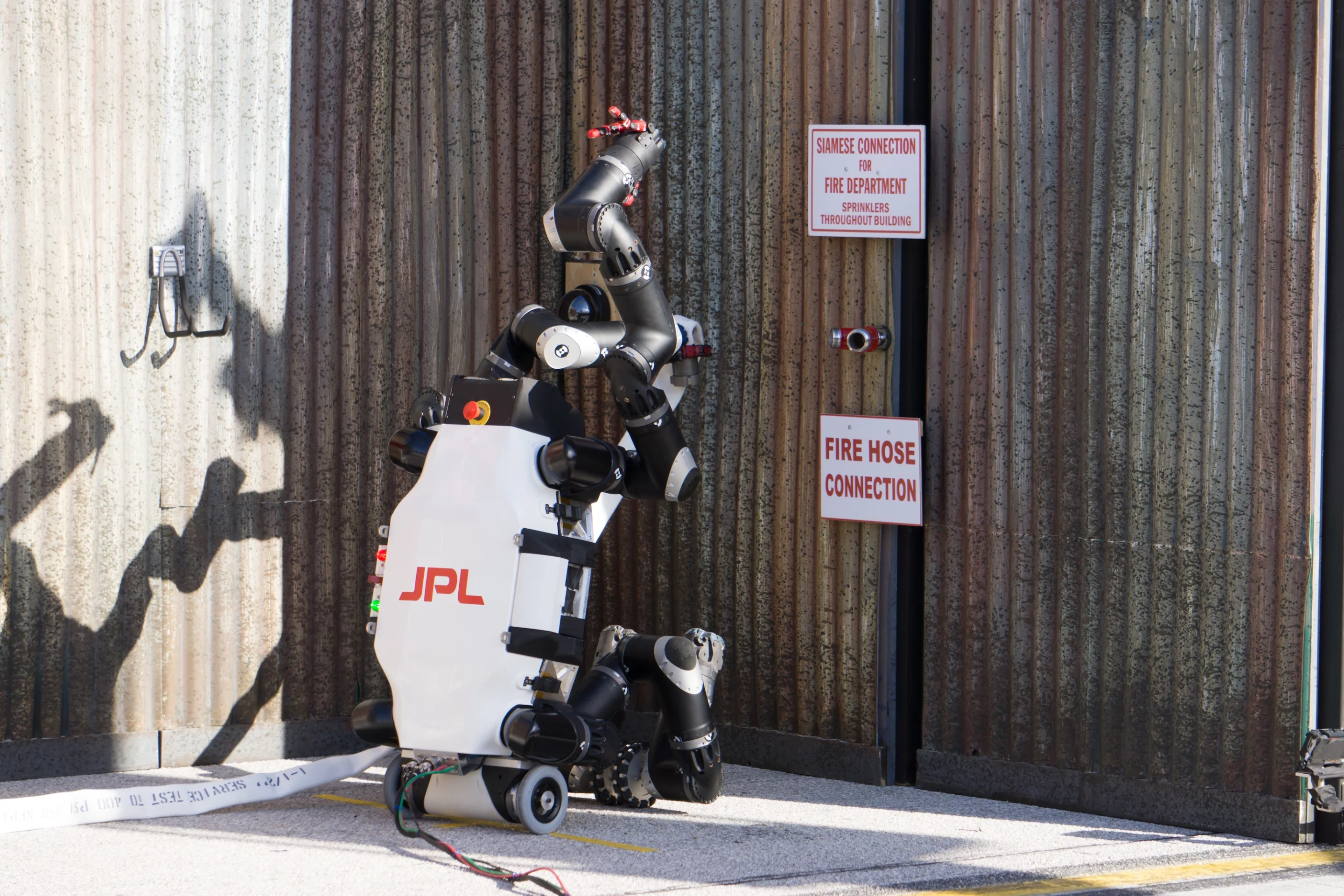 RoboSimian carrying a fire hose