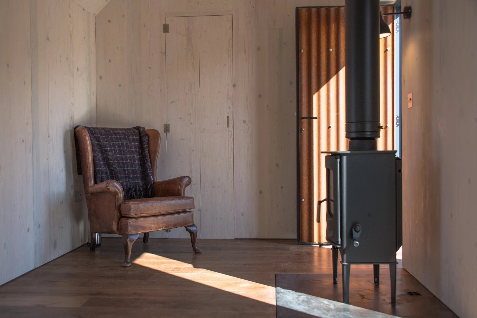 Optional extras for the Artist Bothy include a wood-burning stove