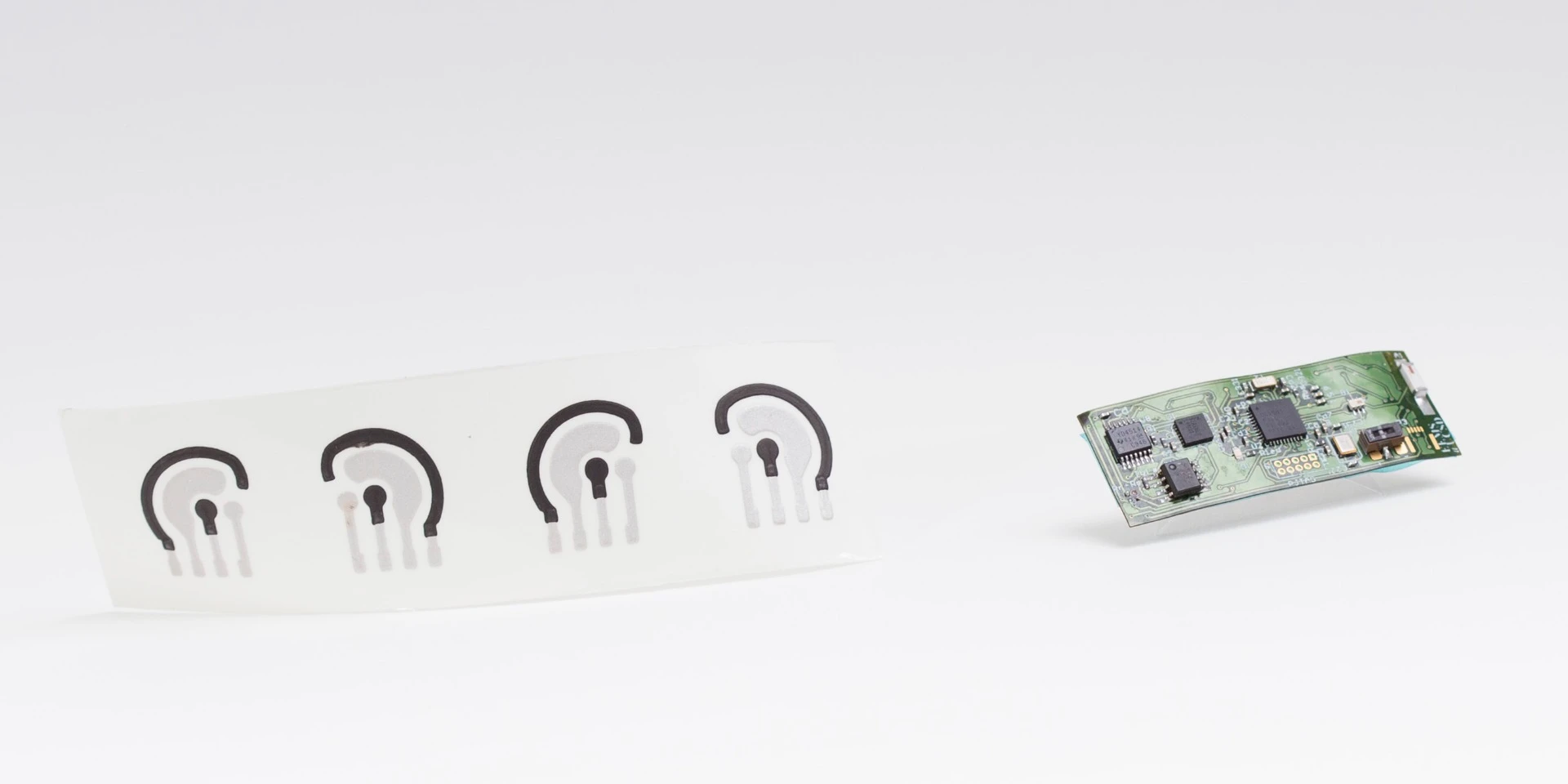 A printed, flexible circuit board is magnetically attached to the tattoo to provide it with power and Bluetooth functionality