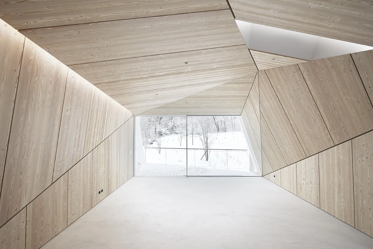 Wooden panels elegantly frame the large floor-to-ceiling window, transforming the view into a work of art