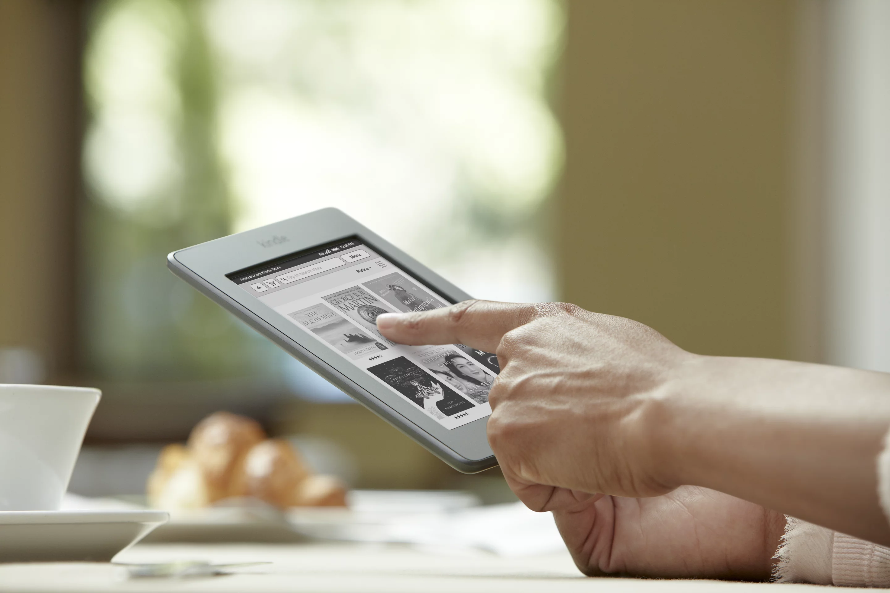 The Kindle Touch screen uses infra-red technology, so it requires only the lightest of touches to register